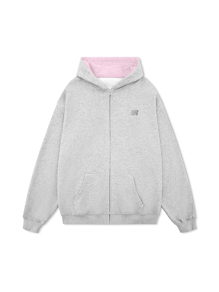 Product photography of a grey street-style hoodie with pastel pink interior lining and ribbed cuffs.