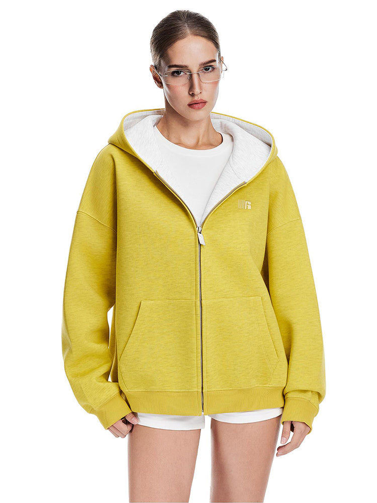 Front view of a vibrant yellow oversized zip-up hoodie with white contrast lining for a streetwear aesthetic.