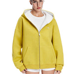Front view of a vibrant yellow oversized zip-up hoodie with white contrast lining for a streetwear aesthetic.