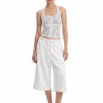 Full body shot of model in FDR Studios casual monochromatic white streetwear halter vest and slouchy culottes.