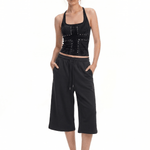 FDR Studios minimalist gothic black halter top and matching black wide-leg relaxed capri pants on model.