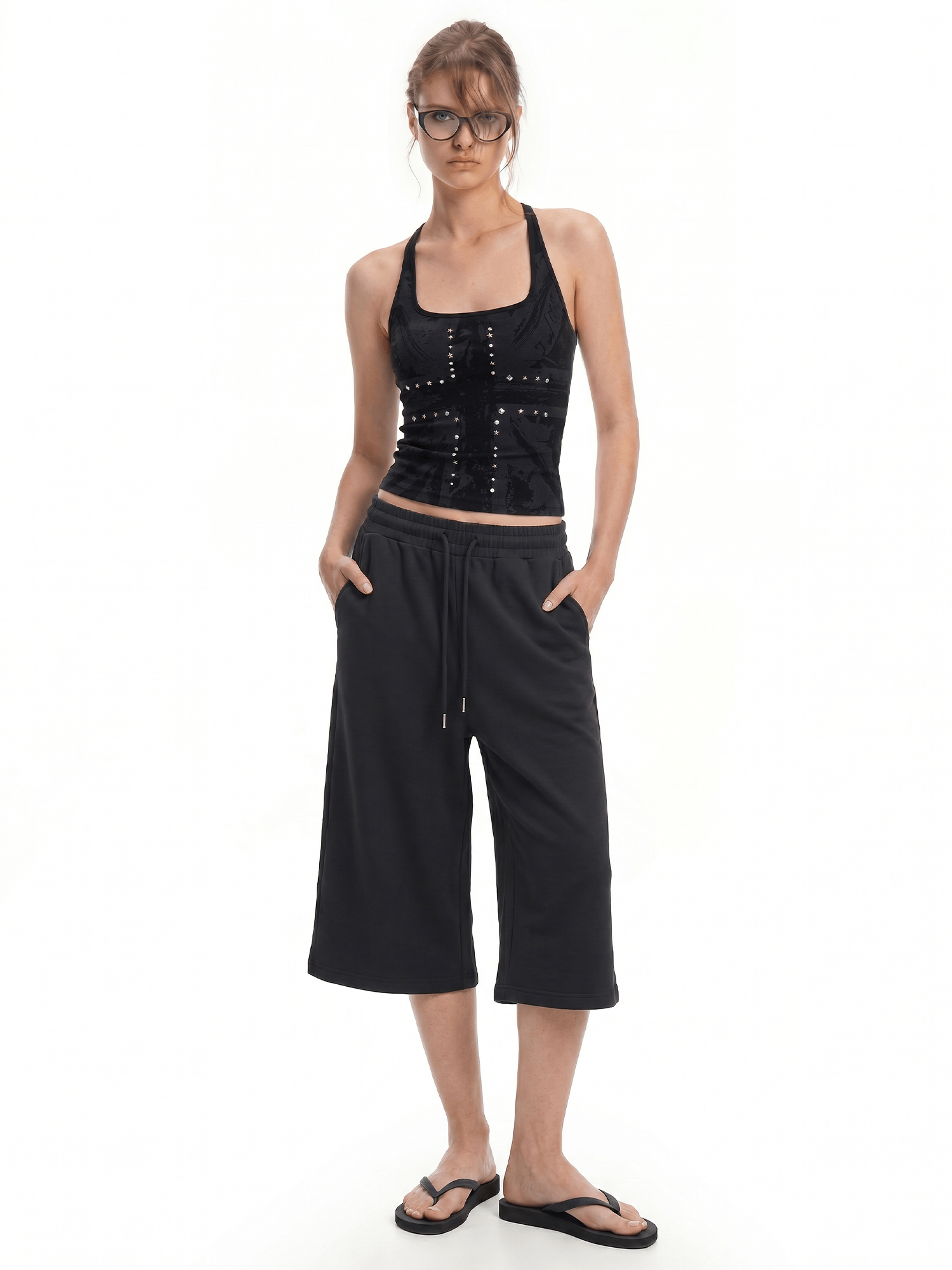 FDR Studios minimalist gothic black halter top and matching black wide-leg relaxed capri pants on model.