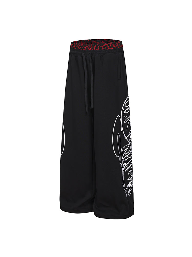 Streetwear black joggers featuring oversized tribal graphic on the leg
