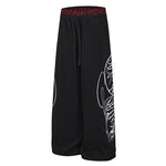 Streetwear black joggers featuring oversized tribal graphic on the leg