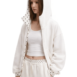 Close-up shot of a female model wearing an off-white oversized hoodie with a wide hood and checkered patterned inner lining, high-street fashion aesthetic.