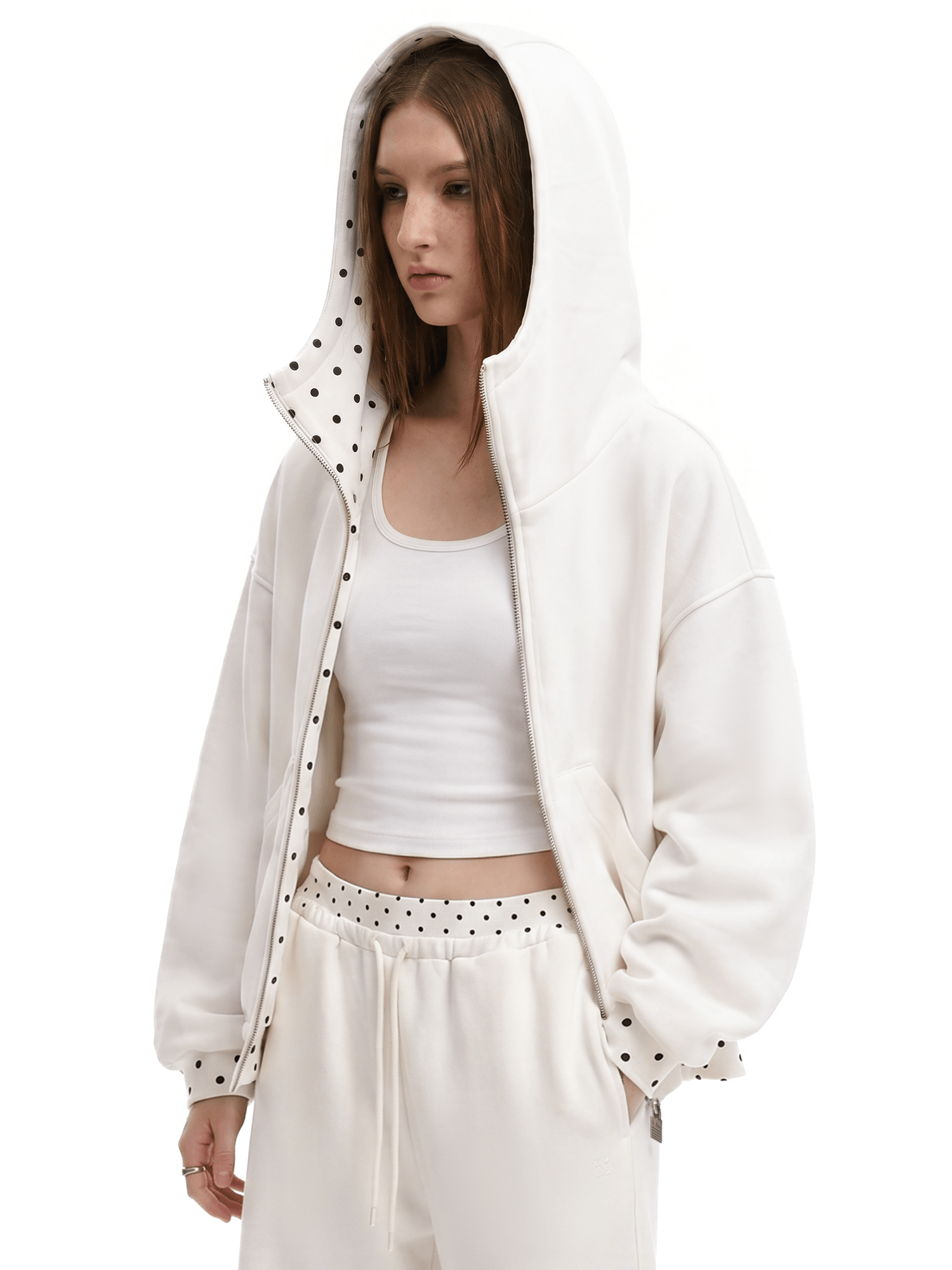 Close-up shot of a female model wearing an off-white oversized hoodie with a wide hood and checkered patterned inner lining, high-street fashion aesthetic.