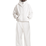 Full body front view of a male model posing in an off-white baggy cyber y2k style tracksuit with an oversized zip-up hoodie and loose-fit sweatpants.