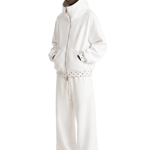 Side profile view of a male model wearing a premium off-white heavy knit oversized streetwear tracksuit, showcasing the relaxed silhouette and baggy fit.