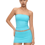 Model wearing FDR Studios LAKE blue double-lined seamless tube top and mini skirt set, close-up view, cyber Y2K fashion aesthetic.