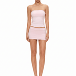 Model in baby pink double-lined seamless tube top and mini skirt matching co-ord set, avant-garde cyber Y2K style by FDR Studios.