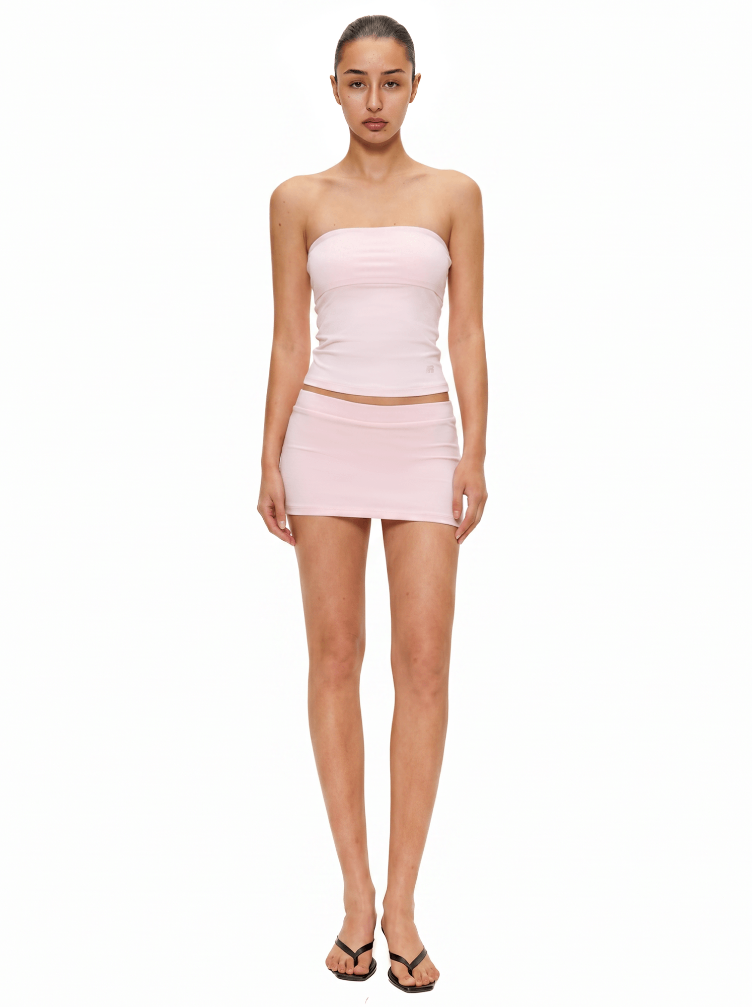 Model in baby pink double-lined seamless tube top and mini skirt matching co-ord set, avant-garde cyber Y2K style by FDR Studios.