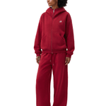 FDR independent fashion label burgundy red oversized zip-up hoodie and baggy track pants on female model, minimalist high-street loungewear.