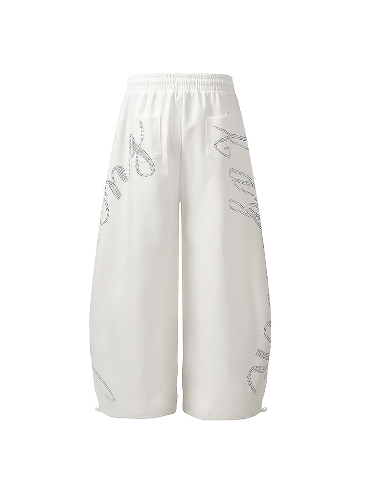 Back view of white wide-leg sweatpants showing clean design and oversized fit.