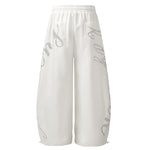 Back view of white wide-leg sweatpants showing clean design and oversized fit.