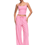 FDR Studios cyber minimalist pink spaghetti strap camisole and baggy drawstring sweatpants.