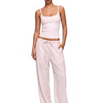 FDR Studios high-street aesthetic pastel pink spaghetti strap cami and relaxed-fit baby pink lounge pants on model.