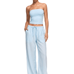 Model wearing FDR Studios Y2K aesthetic soft blue strapless crop top and baggy high-waisted lounge pants.