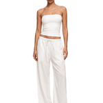 FDR Studios industrial minimalist cream white strapless tube top paired with matching off-white relaxed sweatpants.