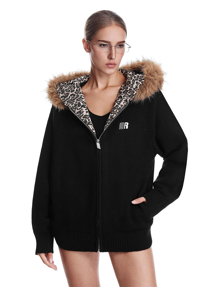 Cyber Y2K aesthetic black zip-up jacket with industrial minimalist fur hood design.