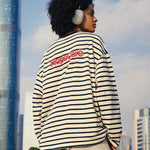 Back view of HypeCord striped long-sleeve tee showing the red brand logo embroidery.