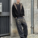 Heavyweight black oversized hoodie with leopard hood contrast on male model.