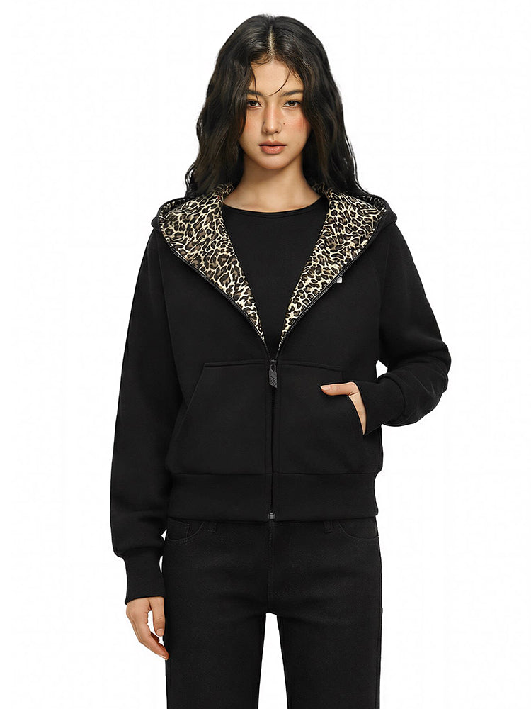 Female model wearing FDR leopard-lined black hoodie in a dynamic high-street pose.