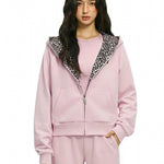 Profile view of FDR pink hoodie highlighting the oversized hood and cropped fit.