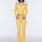 Model wearing yellow Y2K plush zip hoodie with white faux fur collar and matching sweatpants