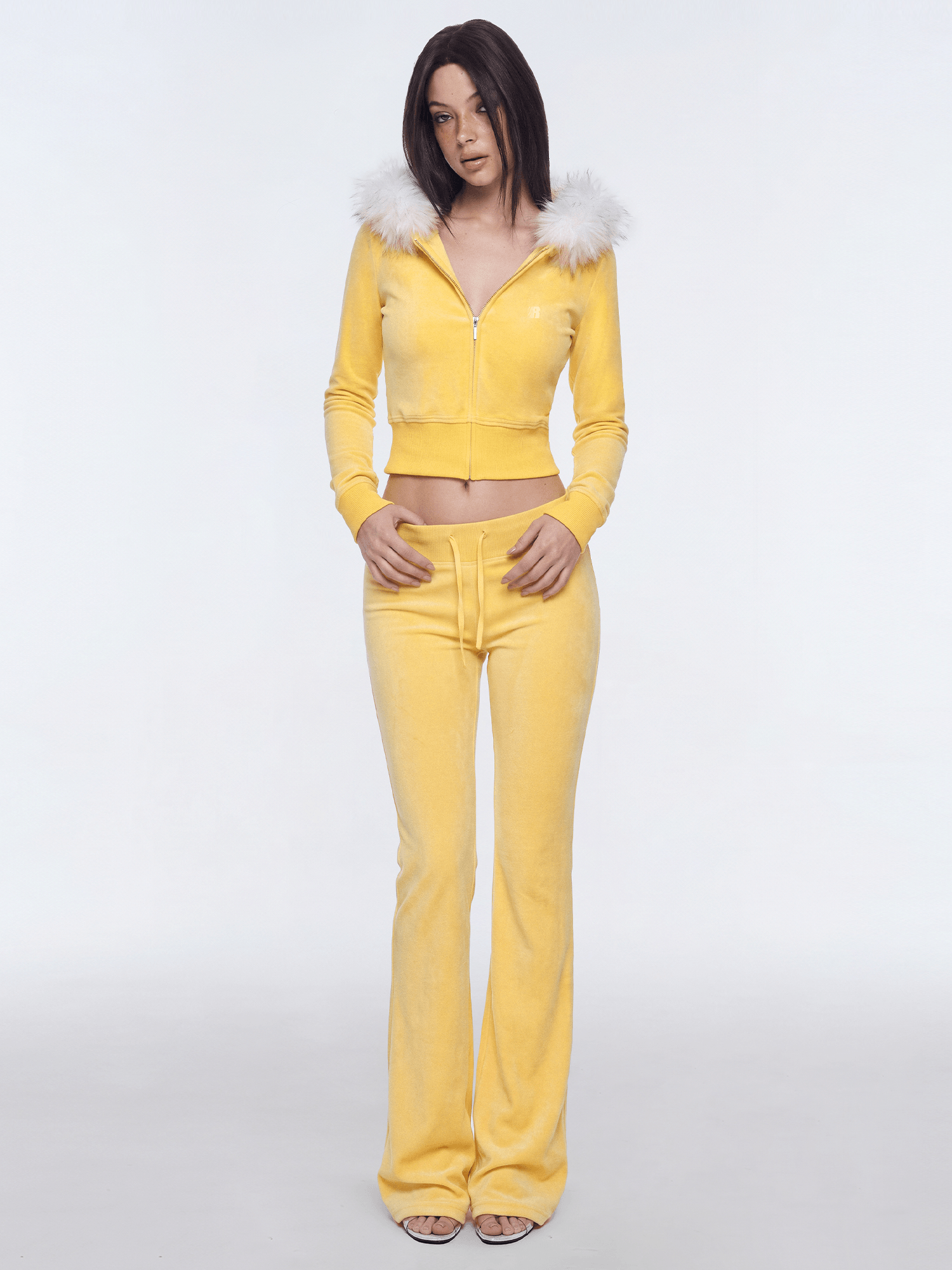Model wearing yellow Y2K plush zip hoodie with white faux fur collar and matching sweatpants