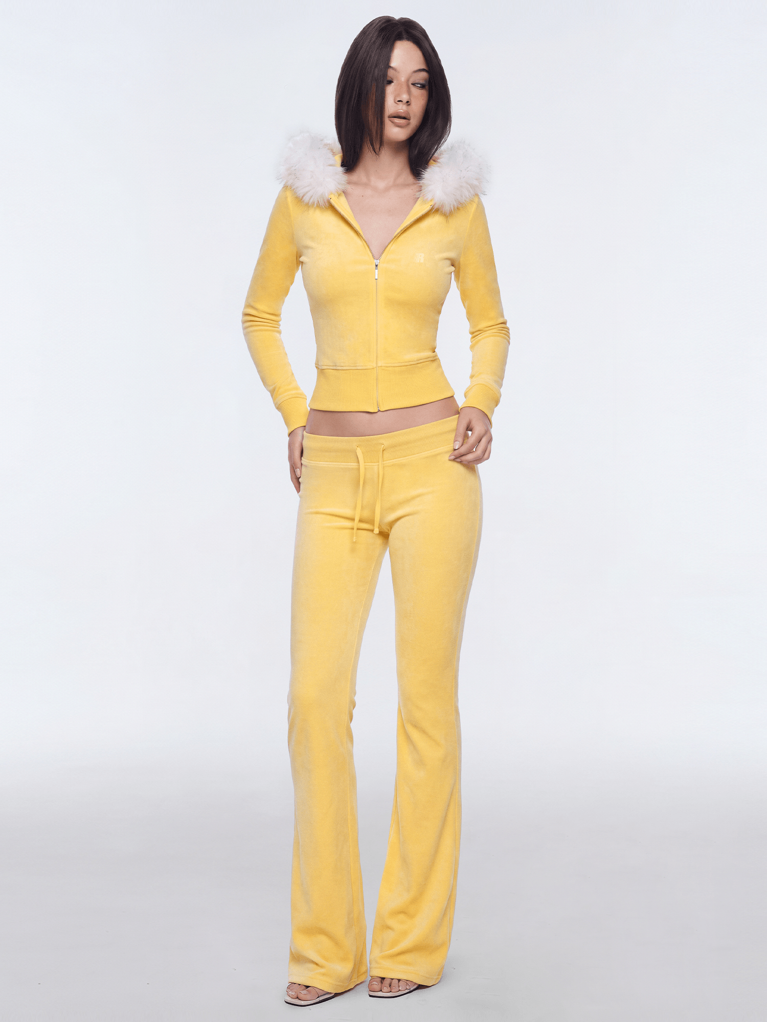 Model showcasing yellow cropped faux fur zip hoodie tracksuit set