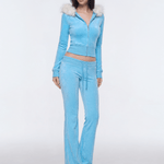 Side view of model wearing light blue Y2K faux fur zip hoodie tracksuit