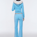 Back view of model wearing light blue Y2K plush zip hoodie with faux fur hood