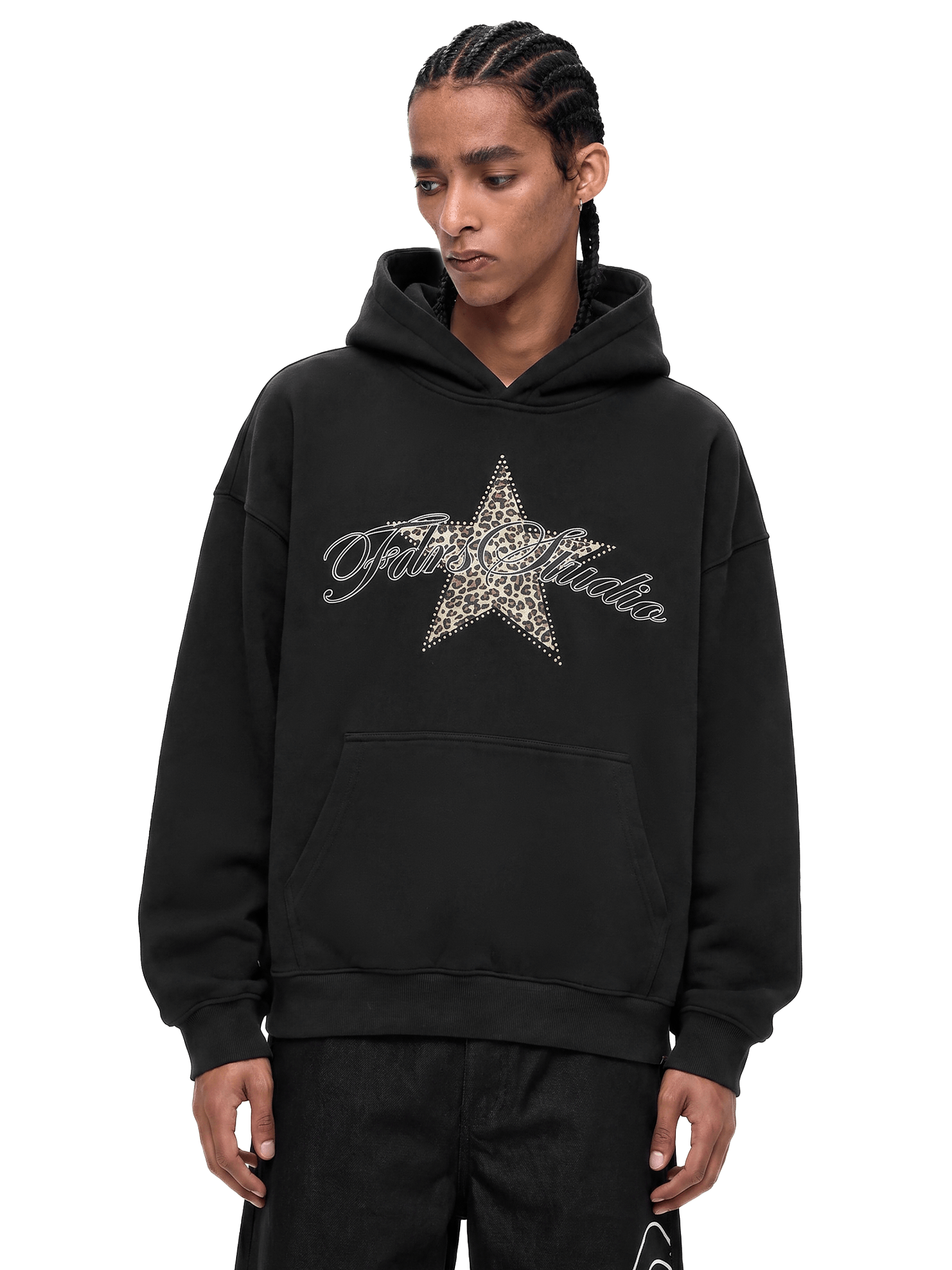 Close-up shot of a black streetwear hoodie featuring a distressed star graphic on the chest with a model posing.