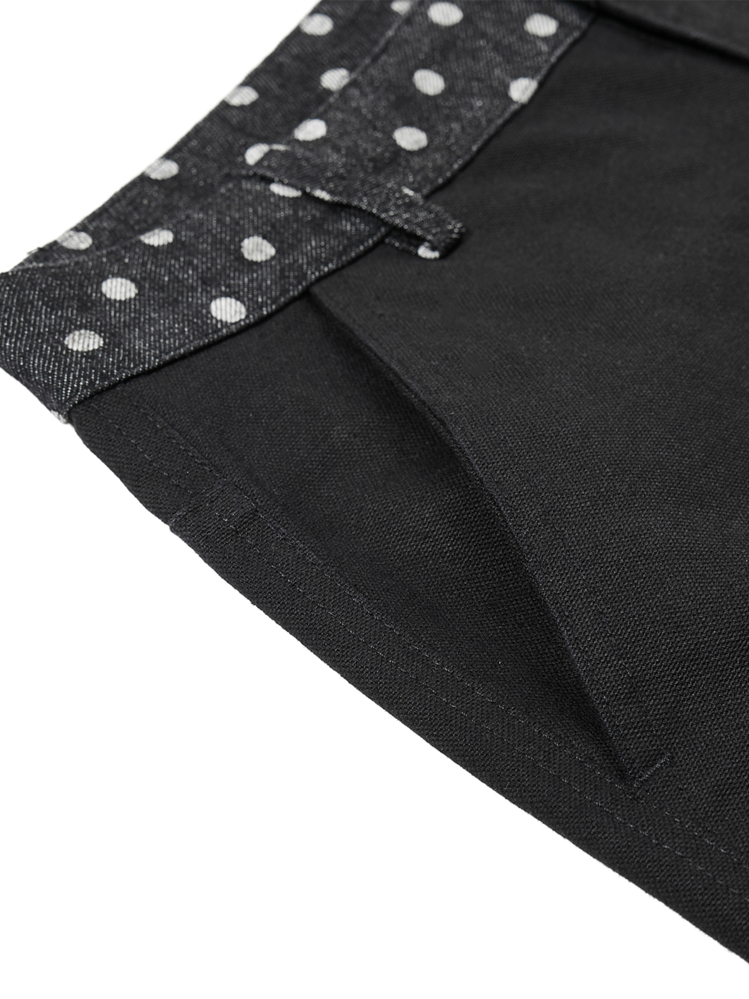 Detail shot of the side pocket and silver-tone rivet hardware on black heavy-duty cotton trousers.