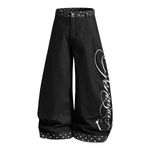 Front view of black ultra-wide-leg streetwear trousers featuring a baggy fit and oversized silhouette.