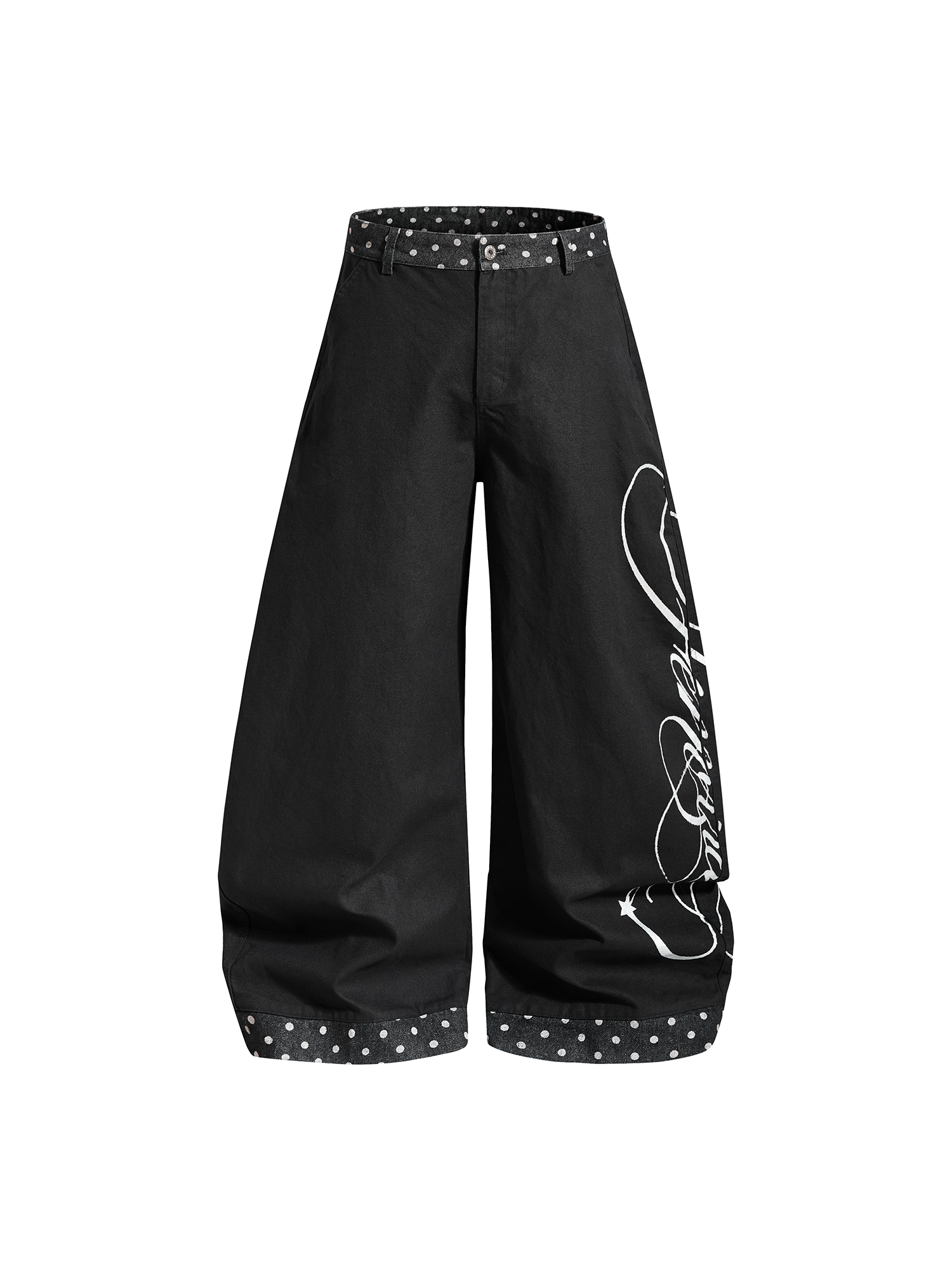 Angled view of black oversized trousers highlighting the white artistic script embroidery on the side.