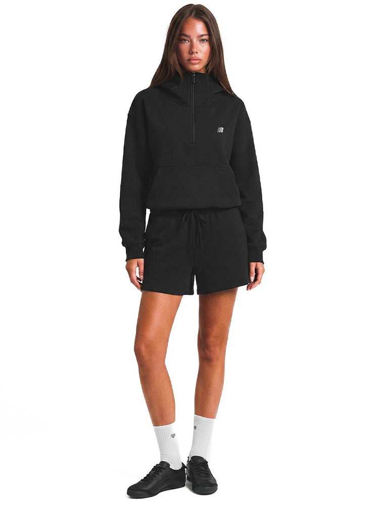 Front view of black unisex oversized hoodie featuring large hood, silver half-zip, and adjustable toggle drawstring hem.