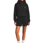 Front view of black unisex oversized hoodie featuring large hood, silver half-zip, and adjustable toggle drawstring hem.