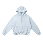 Product flat lay of the light blue unisex oversized hoodie with adjustable bungee drawstring hem.