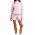 Model wearing the FDR half-zip hoodie in pastel pink paired with matching drawstring shorts.