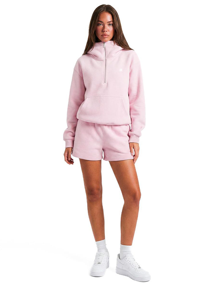 Close-up of the oversized pink hoodie showing the architectural high-funnel neck and silver zipper.