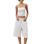 Full-body front view of a model wearing a light gray spaghetti-strap camisole cropped top and matching light gray loose knee-length shorts.