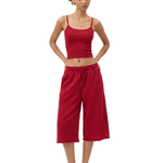 Full-body front view of a model wearing a dark red spaghetti-strap camisole cropped top and matching dark red loose knee-length shorts.