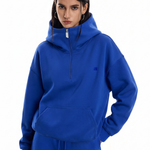 Close-up of FDR Studios royal blue half-zip hoodie with minimalist industrial design.