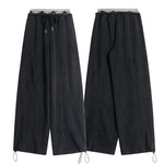 Front and back product view of black wide-leg sweatpants featuring adjustable drawstring cuffs.