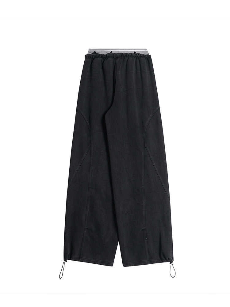 Back view of black minimalist wide-leg pants showing the clean construction and fabric texture.
