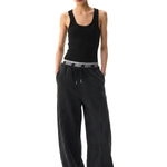 Front view of a female model wearing high-waisted black wide-leg cargo pants and a black ribbed tank top.
