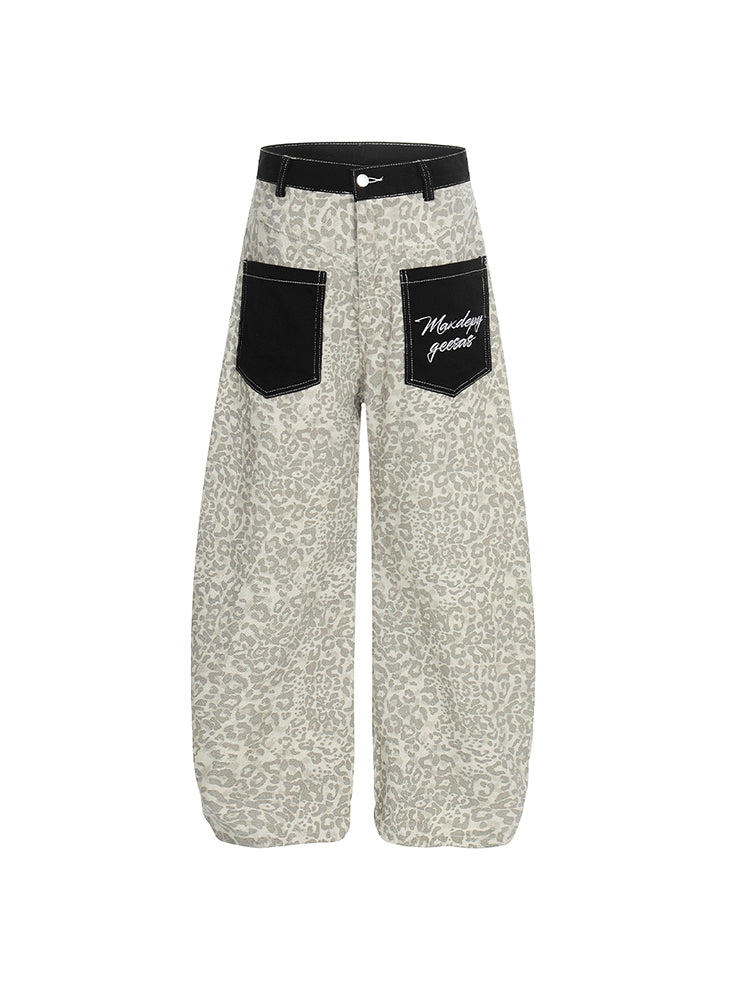 Front view of light beige leopard print wide-leg pants with contrasting black cargo pockets.