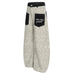 Rear view of light khaki leopard print baggy pants showcasing the black utility pocket design.