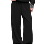 raw utilitarian style black baggy sweatpants with exposed polka dot double waistband and elongated thick drawstrings